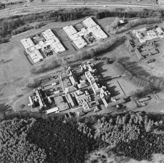 Oblique aerial view centred on the asylum with the hospital adjacent, taken from the SSW.