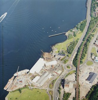 Oblique aerial view centred on the castle and shipyard, taken from the W.