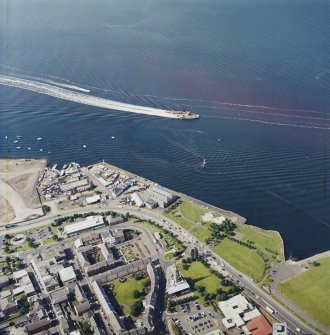 Oblique aerial view centred on the tolbooth and the quay with the Waverley Steamer passing by, taken from the S.