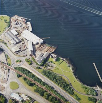 Oblique aerial view centred on the castle and shipyard, taken from the SE.