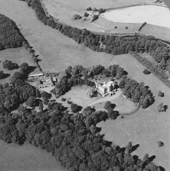 Oblique aerial view centred on the castle, tower-house and stables with the remains of rig adjacent, taken from the SE.