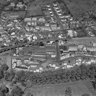 Aerial view of Newmilns railway viaduct and factories, centred on the site of Greenhead Mills, taken from the SSW.