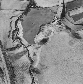 Oblique aerial view centred on the remains of the railway viaduct, taken from the E.