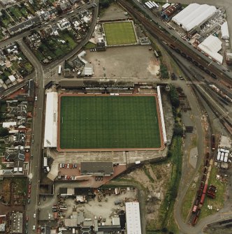 Oblique aerial view centred on the football stadium, taken from the NNE.