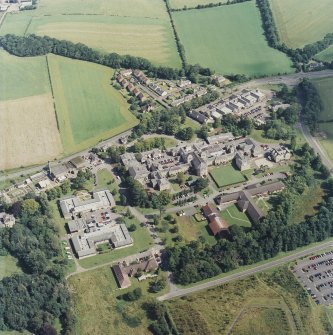 Oblique aerial view centred on the hospital, taken from the SW.