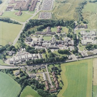 Oblique aerial view centred on the hospital, with the hospital adjacent, taken from the NNE.