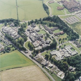 Oblique aerial view centred on the hospital, with the hospital adjacent, taken from the NW.