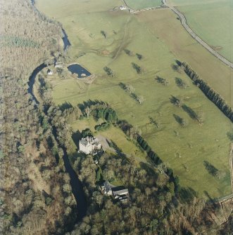 Oblique aerial view centred on the tower-house with the stables and kennels adjacent, taken from the W.