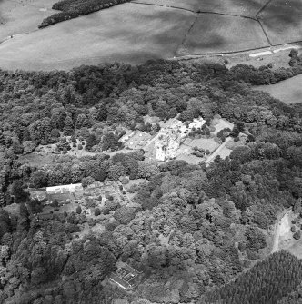 Oblique aerial photograph of Glenapp Castle taken from the SW, centred on the country house, walled garden and cottage with the garage cottage visible in the bottom of the photograph.