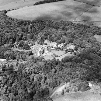 Oblique aerial photograph of Glenapp Castle taken from the SSW, centred on the country house, with the walled garden in the left centre of the photograph.