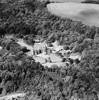 Oblique aerial photograph of Glenapp Castle taken from the SSE, centred on the country house, with the walled garden in the left centre of the photograph.