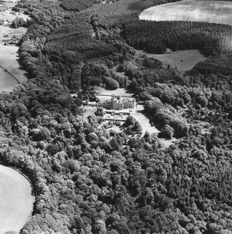 Oblique aerial photograph of Glenapp Castle taken from the SW, centred on the country house, with the walled garden and cottage in the right centre of the photograph.