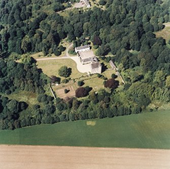 Oblique aerial view of Killochan Castle centred on the tower-house with the stables adjacent, taken from the S.