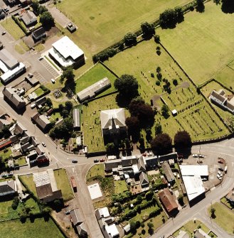 Oblique aerial view of Tarbolton centred on the church and churchyard, taken from the NNE.