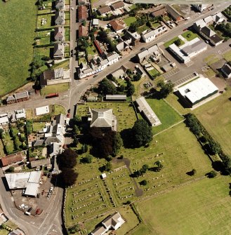 Oblique aerial view of Tarbolton centred on the church and churchyard, taken from the WNW.