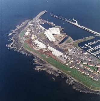 Oblique aerial view centred on the harbour, taken from the SSW.