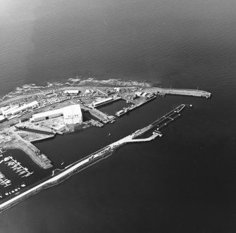Oblique aerial view centred on the harbour, taken from the ENE.