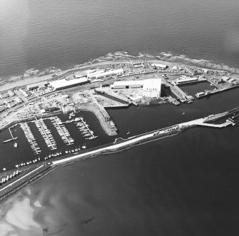 Oblique aerial view centred on the harbour, taken from the NE.