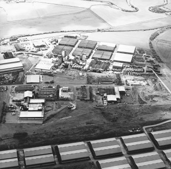 Oblique aerial view centred on the whisky distillery, taken from the N.