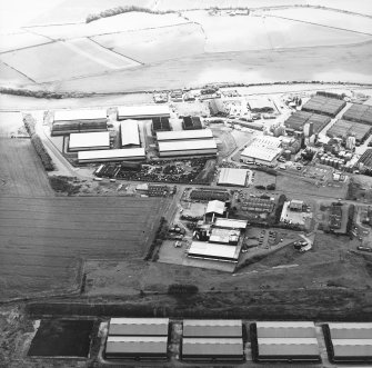 Oblique aerial view centred on the whisky distillery, taken from the NW.