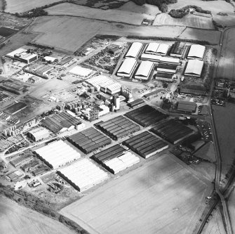 Oblique aerial view centred on the whisky distillery, taken from the SW.