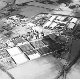 Oblique aerial view centred on the whisky distillery, taken from the SW.