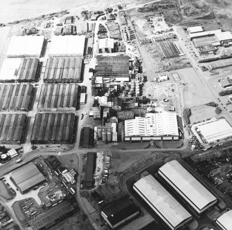 Oblique aerial view centred on the whisky distillery, taken from the E.