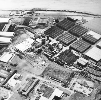 Oblique aerial view centred on the whisky distillery, taken from the NNW.