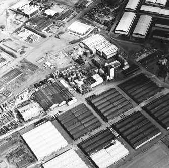 Oblique aerial view centred on the whisky distillery, taken from the SW.