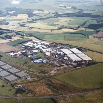 General oblique aerial view looking across the whisky distillery, taken from the WNW.