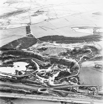Tam's Loup Quarry, oblique aerial view, taken from the SSE, showing the whinstone quarry in the bottom centre of the photograph.