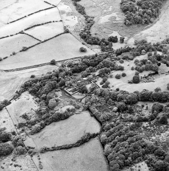 Formakin, oblique aerial view, taken from the ENE, centred on Formakin Mill, and out-buildings and the gateway of Formakin House.