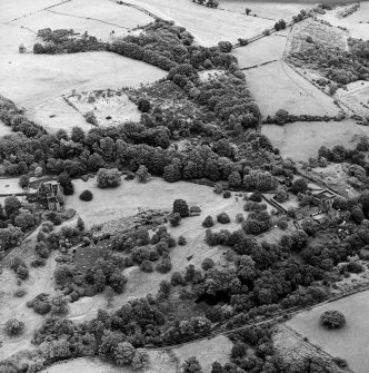 Formakin, oblique aerial view, taken from the NW, showing Formakin Mill, and out-buildings and the gatehouse of Formakin House in the centre right of the photograph, and Formakin House itself in the centre left.