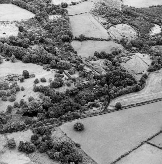 Formakin, oblique aerial view, taken from the W, centred on Formakin Mill, and out-buildings of Formakin House.