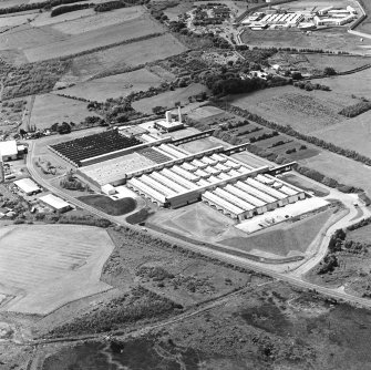 Oblique aerial view of Shottskirk Road centred on Cummins Engine Factory, taken from the ENE.