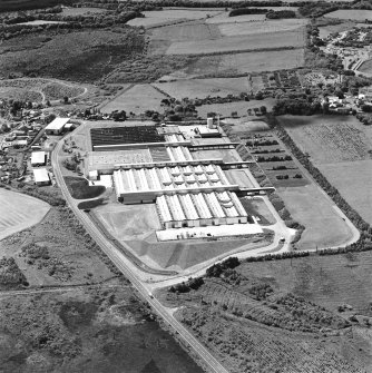 Oblique aerial view of Shottskirk Road centred on Cummins Engine Factory, taken from the NE.