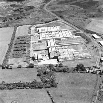 Oblique aerial view of Shottskirk Road centred on Cummins Engine Factory, taken from the SW.