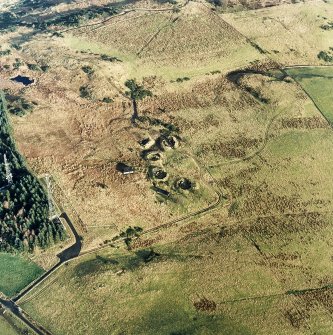 Oblique aerial view centred on the remains of the anti-aircraft battery with traces of the camp adjacent, taken from the WSW.