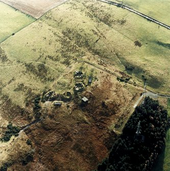 Oblique aerial view centred on the remains of the anti-aircraft battery with traces of the camp adjacent, taken from the NNE.