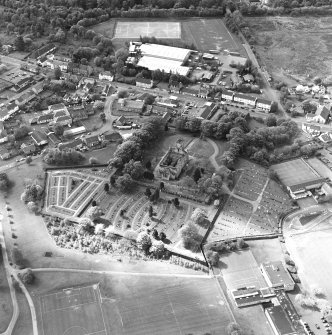 Oblique aerial view of Lennoxtown centred on the remains of the church and cemetery, taken from the NE.