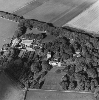 Oblique aerial view of the tower-house, country house, farmsteading and horsemill, taken from the SSE.