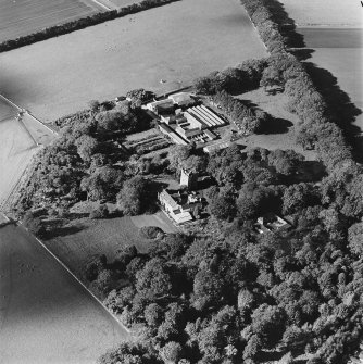 Oblique aerial view of the tower-house, country house, farmsteading and horsemill, taken from the ESE.