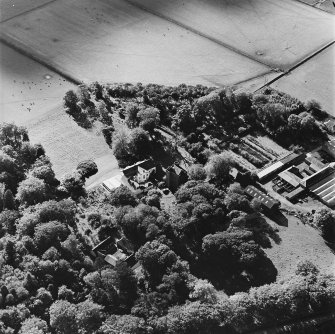 Oblique aerial view of the tower-house, country house, farmsteading and horsemill, taken from the NNE.
