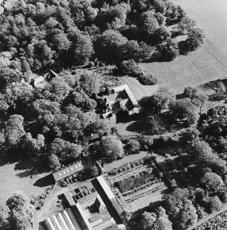 Oblique aerial view of the tower-house, country house, farmsteading and horsemill, taken from the NW.