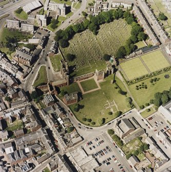 Oblique aerial view centred on the remains of the abbey and churchyard, taken from the S.