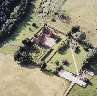 Oblique aerial view centred on the remains of the castle, and the walled garden and custodian¿s house, taken from the ESE.