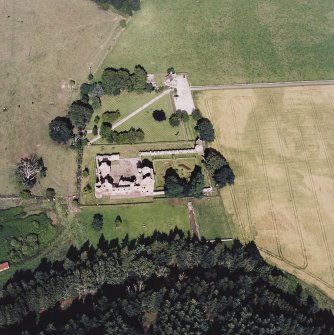 Oblique aerial view centred on the remains of the castle, and the walled garden and custodian¿s house, taken from the WSW.