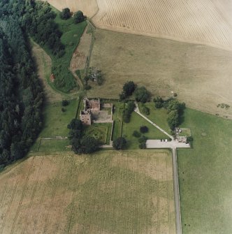 Oblique aerial view centred on the remains of the castle and gardens with custodians house adjacent, taken from the SE.