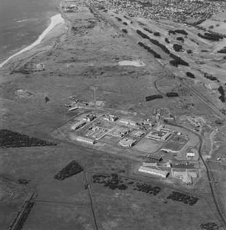 Oblique aerial view of Buddon Camp and magazine, with rifle ranges in the background, taken from the E.