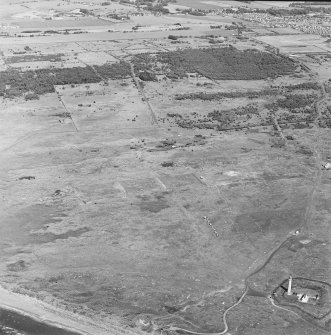 Oblique aerial view, centred on the rifle ranges with the lighthouse in the foreground, taken from the S.